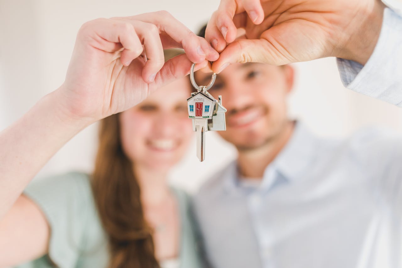services-img Young couple holding keys to their new home, symbolizing a fresh start and investment in real estate.